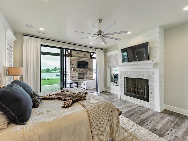 1018 Chaparrel Ln, Graford, TX 76449 - bedroom with a tile fireplace, access to outside, wood finished floors, baseboards, and recessed lighting
