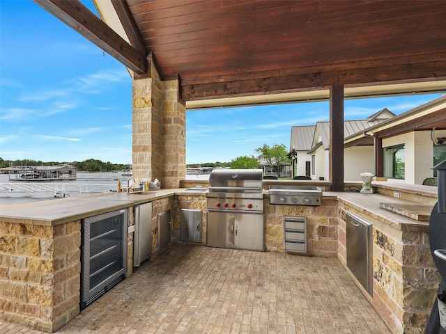 1018 Chaparrel Ln, Graford, TX 76449 - view of patio featuring exterior kitchen, wine cooler, grilling area, and a sink