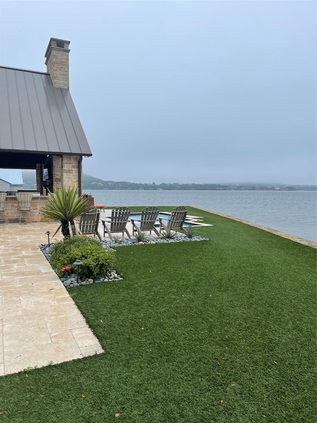 1018 Chaparrel Ln, Graford, TX 76449 - view of grassy yard featuring a water view and a patio area