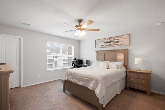 carpeted bedroom with visible vents, a ceiling fan, and baseboards
