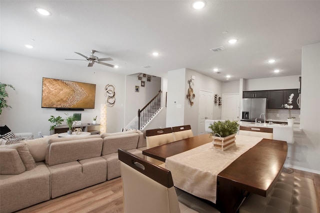 dining space with stairway, ceiling fan, recessed lighting, and visible vents