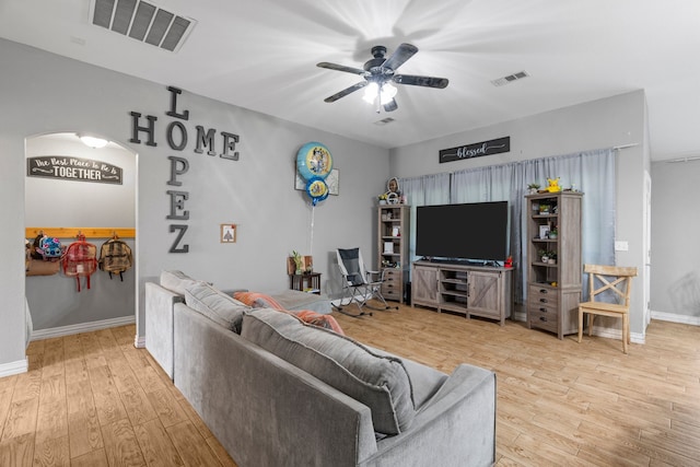 living room with visible vents, baseboards, ceiling fan, and wood finished floors