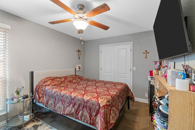 bedroom featuring a closet, baseboards, and a ceiling fan