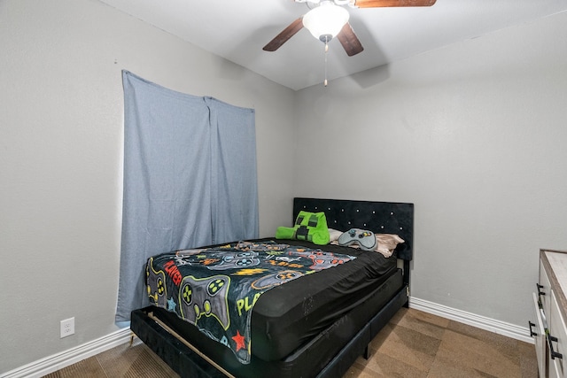 bedroom featuring baseboards and ceiling fan