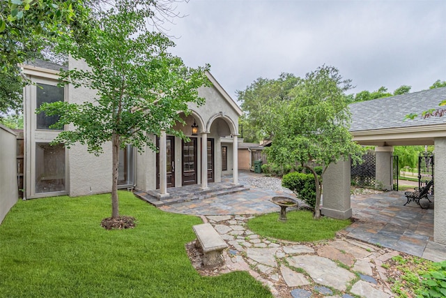 1603 Hawthorne Dr, Arlington, TX 76012 - exterior space featuring a lawn, a patio, fence, and stucco siding