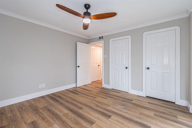1603 Hawthorne Dr, Arlington, TX 76012 - unfurnished bedroom featuring ceiling fan, light wood-style flooring, baseboards, visible vents, and ornamental molding