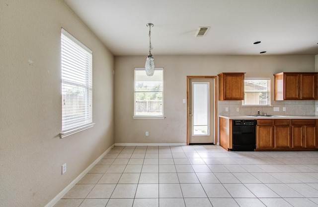 21107 Pine Monte Ridge Ln, Katy, TX 77449 - kitchen featuring brown cabinets, a sink, dishwasher, light countertops, and visible vents