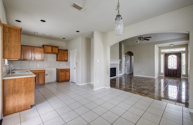 21107 Pine Monte Ridge Ln, Katy, TX 77449 - kitchen with a sink, brown cabinetry, a ceiling fan, open floor plan, and visible vents