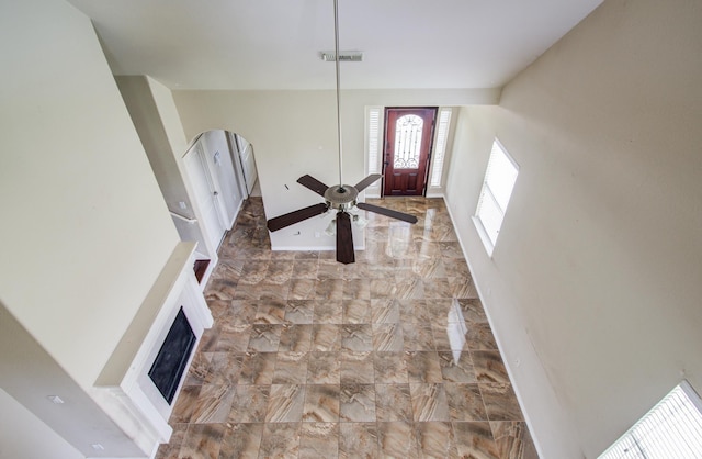 21107 Pine Monte Ridge Ln, Katy, TX 77449 - foyer entrance featuring ceiling fan, visible vents, a fireplace, baseboards, and marble finish floor