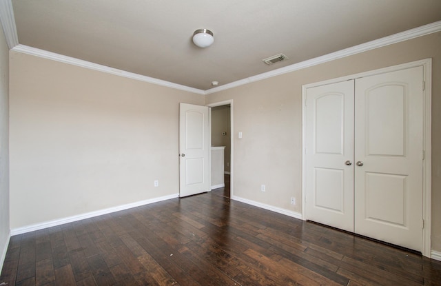 21107 Pine Monte Ridge Ln, Katy, TX 77449 - unfurnished bedroom with visible vents, ornamental molding, a closet, baseboards, and dark wood-type flooring