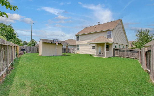 21107 Pine Monte Ridge Ln, Katy, TX 77449 - back of house with a lawn, a storage unit, an outdoor structure, and a fenced backyard