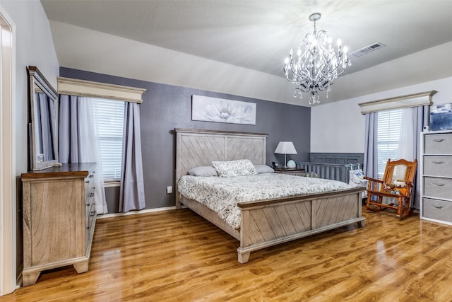 9813 Jericho Ln, Fort Worth, TX 76108 - bedroom featuring a chandelier, light wood-style floors, vaulted ceiling, and baseboards