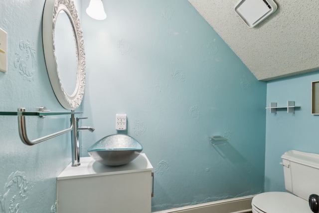 half bathroom with vanity, toilet, and lofted ceiling