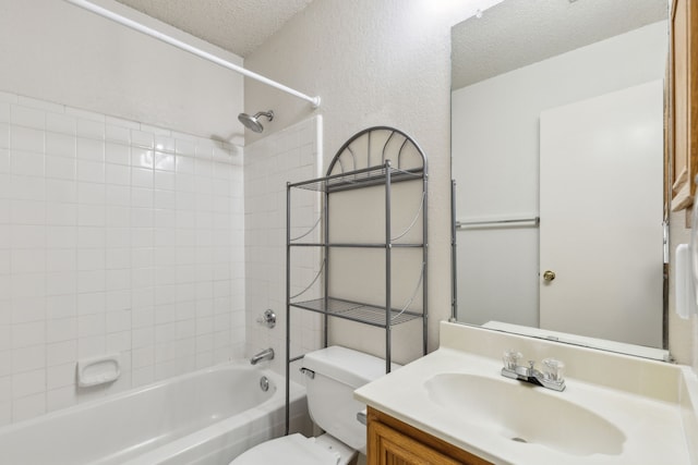 full bath with vanity, a textured ceiling, toilet, and shower / washtub combination