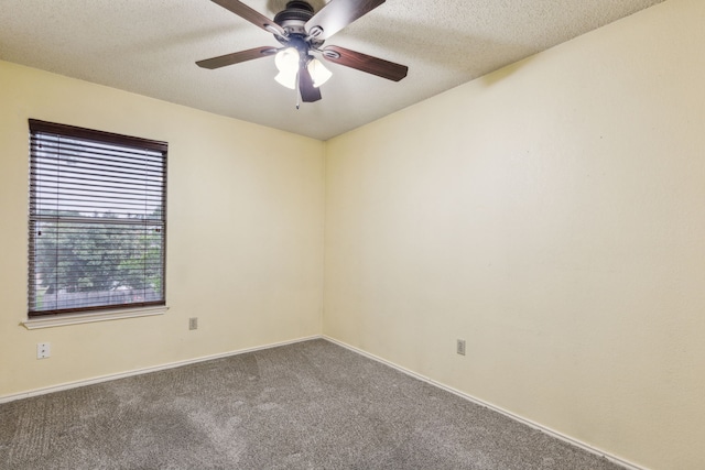 spare room featuring carpet flooring, a textured ceiling, ceiling fan, and baseboards