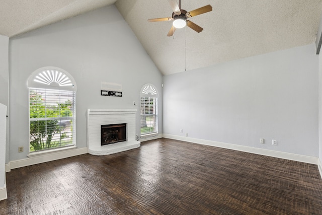 unfurnished living room featuring a brick fireplace, ceiling fan, baseboards, and high vaulted ceiling