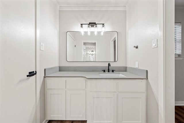 bathroom with vanity, ornamental molding, and baseboards