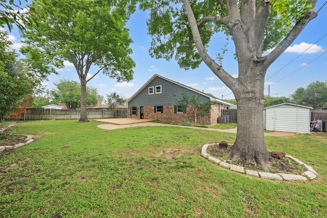 back of house with a fenced backyard, a yard, and a patio area