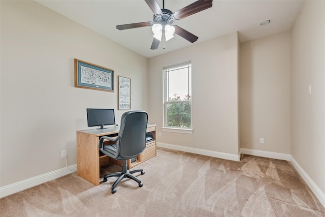 office area featuring light colored carpet, baseboards, and ceiling fan