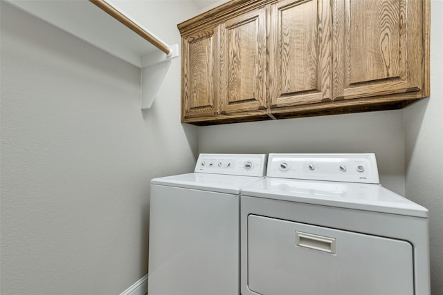 laundry area with cabinet space and washer and clothes dryer