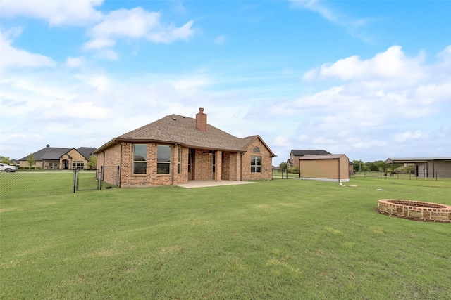 back of house featuring brick siding, a gate, a fenced backyard, and a patio