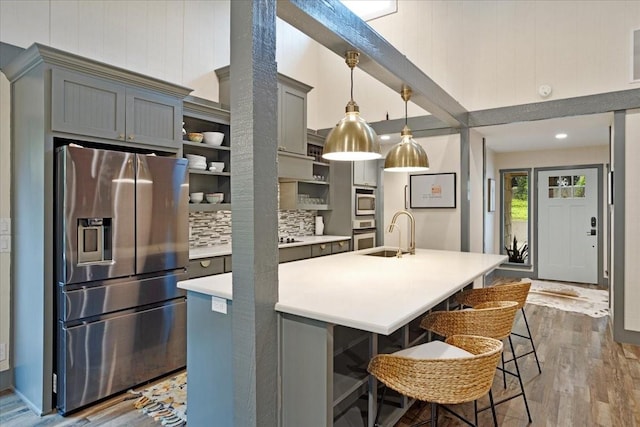 2449 Tanglewood Blvd, Pottsboro, TX 75076 - kitchen featuring appliances with stainless steel finishes, a sink, dark wood-style flooring, light countertops, and open shelves