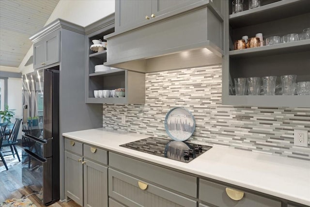 2449 Tanglewood Blvd, Pottsboro, TX 75076 - kitchen featuring open shelves, gray cabinetry, stainless steel fridge, black electric stovetop, and exhaust hood