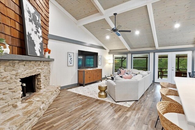 2449 Tanglewood Blvd, Pottsboro, TX 75076 - living area with beam ceiling, wood finished floors, french doors, a fireplace, and high vaulted ceiling