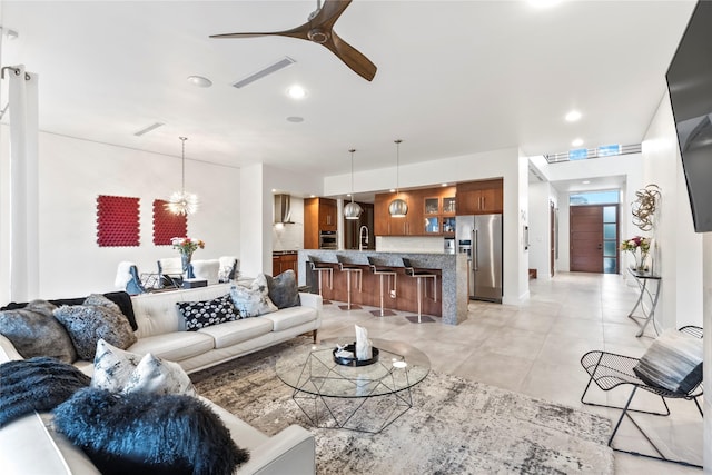 living area with visible vents and ceiling fan