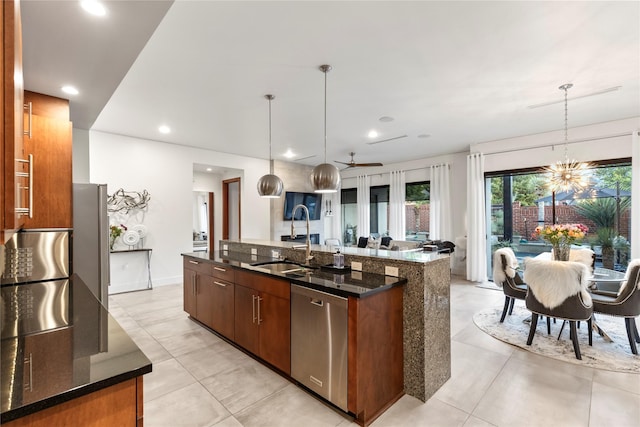 kitchen with stainless steel dishwasher, a sink, dark stone countertops, and an island with sink