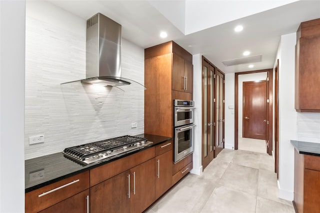 kitchen with backsplash, dark countertops, appliances with stainless steel finishes, and wall chimney exhaust hood