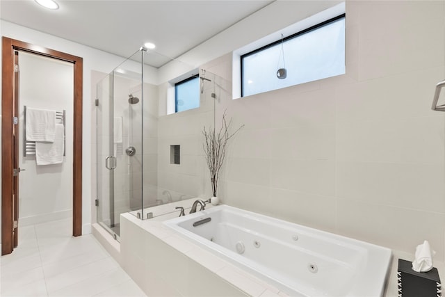 bathroom featuring a shower stall, tile patterned flooring, and a jetted tub