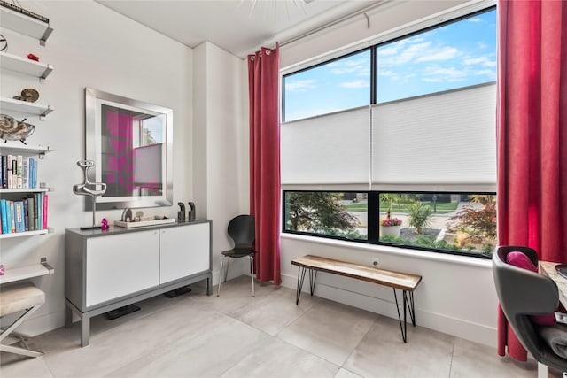 interior space featuring light tile patterned floors and baseboards