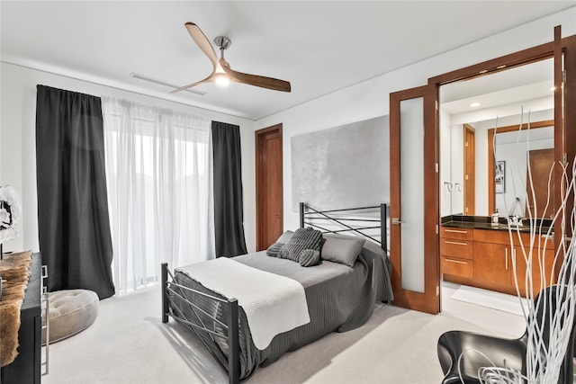 bedroom with a ceiling fan and light colored carpet