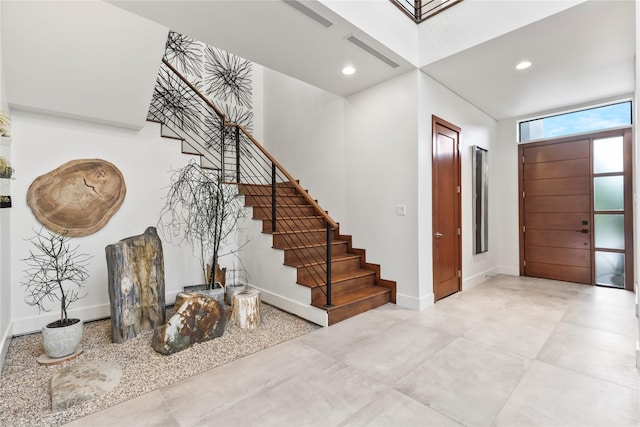 entryway featuring baseboards, recessed lighting, stairs, and visible vents