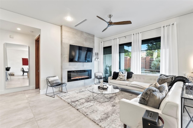 living room with ceiling fan, a fireplace, recessed lighting, and visible vents
