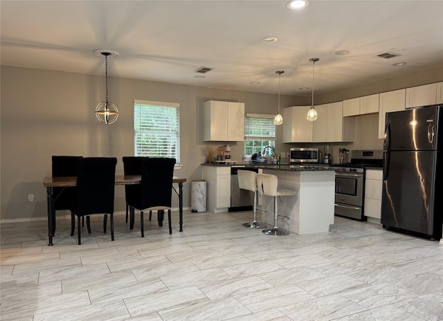 1617 Tyson St, Blue Mound, TX 76131 - kitchen featuring white cabinets, stainless steel appliances, visible vents, and recessed lighting