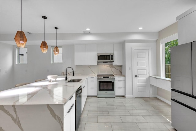 1619 Homeland St, Dallas, TX 75212 - kitchen with a sink, stainless steel appliances, a peninsula, white cabinetry, and modern cabinets