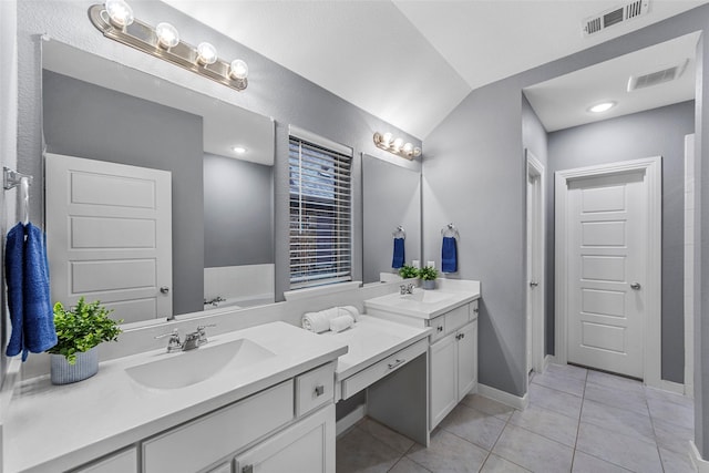 full bathroom featuring visible vents, tile patterned flooring, vaulted ceiling, and vanity