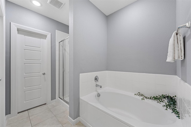 full bath with visible vents, baseboards, tile patterned floors, a bath, and a shower stall