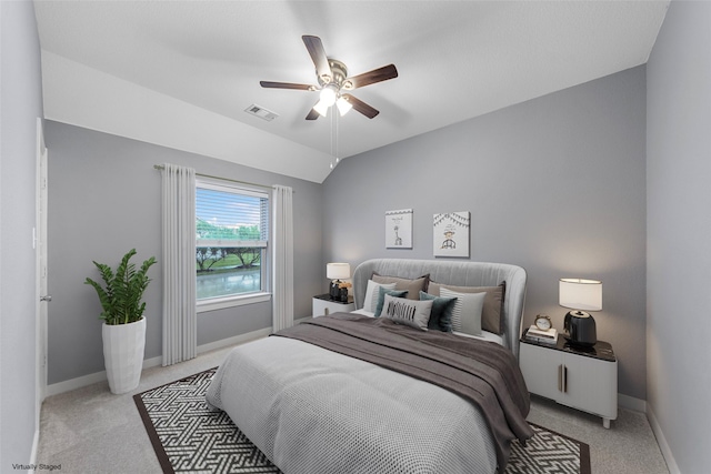 carpeted bedroom featuring baseboards, visible vents, a ceiling fan, and lofted ceiling