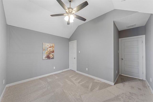 unfurnished bedroom featuring visible vents, carpet flooring, baseboards, and lofted ceiling