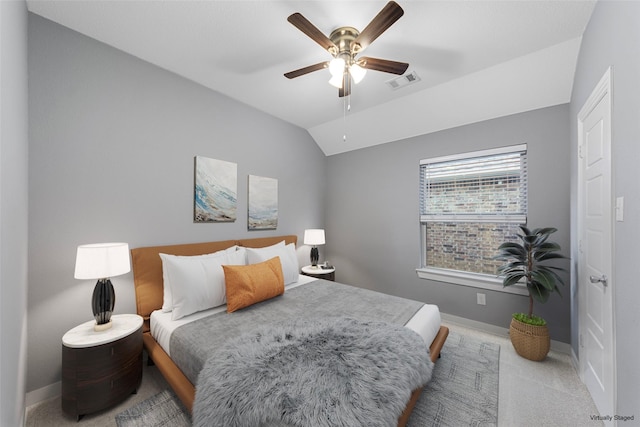 carpeted bedroom with a ceiling fan, baseboards, visible vents, and lofted ceiling