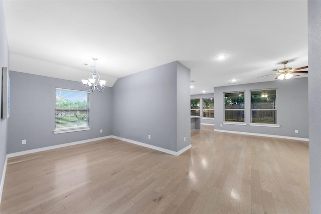 unfurnished room featuring lofted ceiling, baseboards, recessed lighting, light wood finished floors, and ceiling fan with notable chandelier