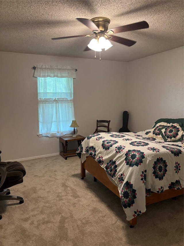 bedroom with baseboards, carpet flooring, a textured ceiling, and ceiling fan
