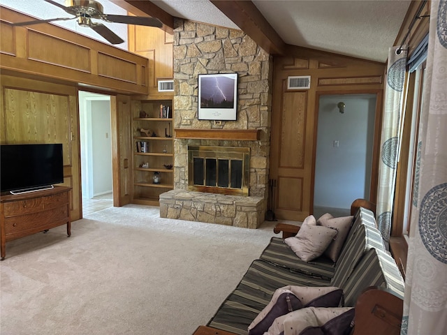 living room with ceiling fan, lofted ceiling with beams, visible vents, and a fireplace