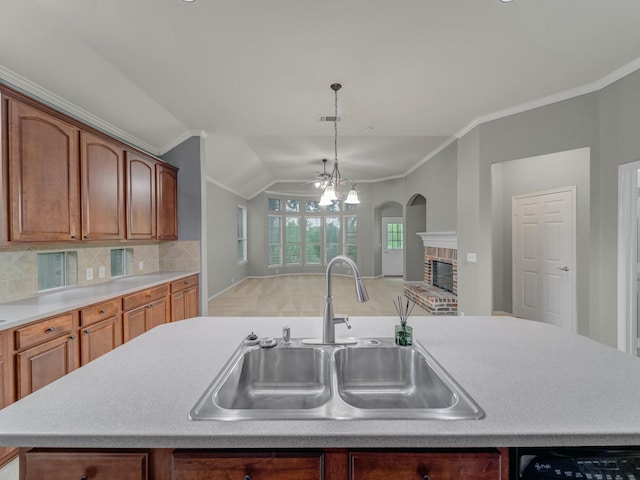 kitchen with a brick fireplace, light countertops, arched walkways, a sink, and vaulted ceiling