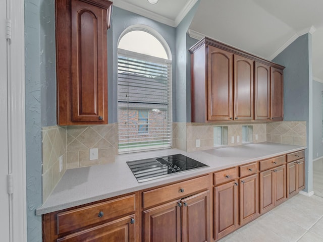 kitchen featuring light countertops, decorative backsplash, ornamental molding, and black electric cooktop