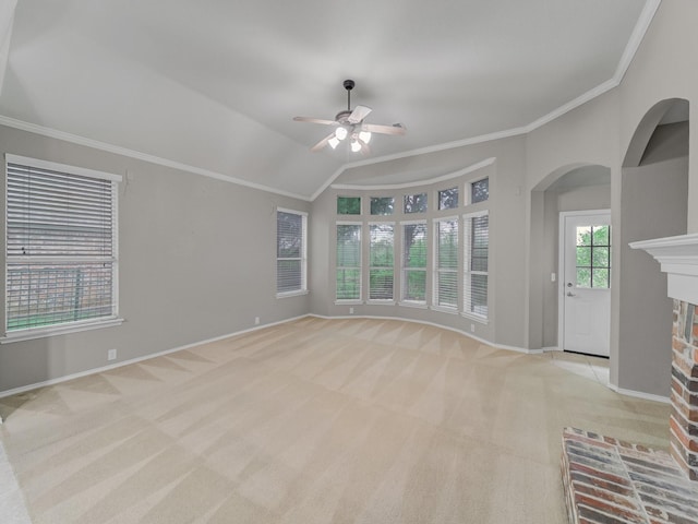 unfurnished living room with ceiling fan, light carpet, baseboards, and ornamental molding