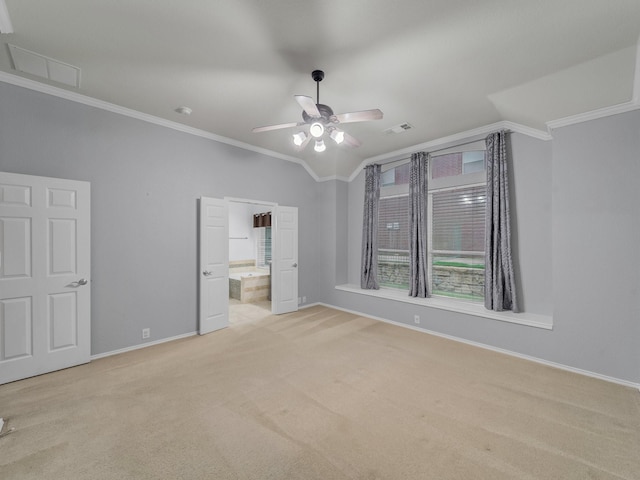 unfurnished bedroom with baseboards, visible vents, ornamental molding, and carpet